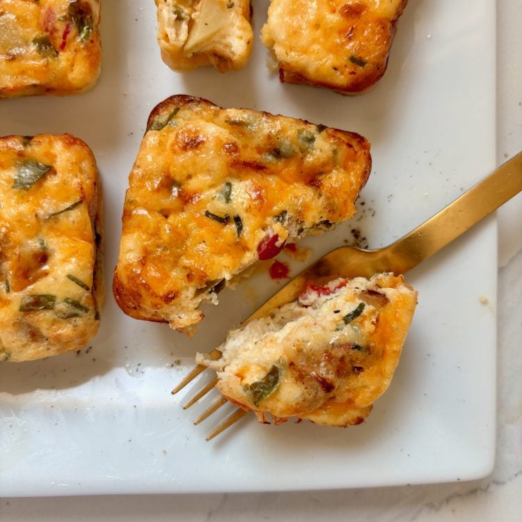 Golden cheesy veggie egg bites with fork