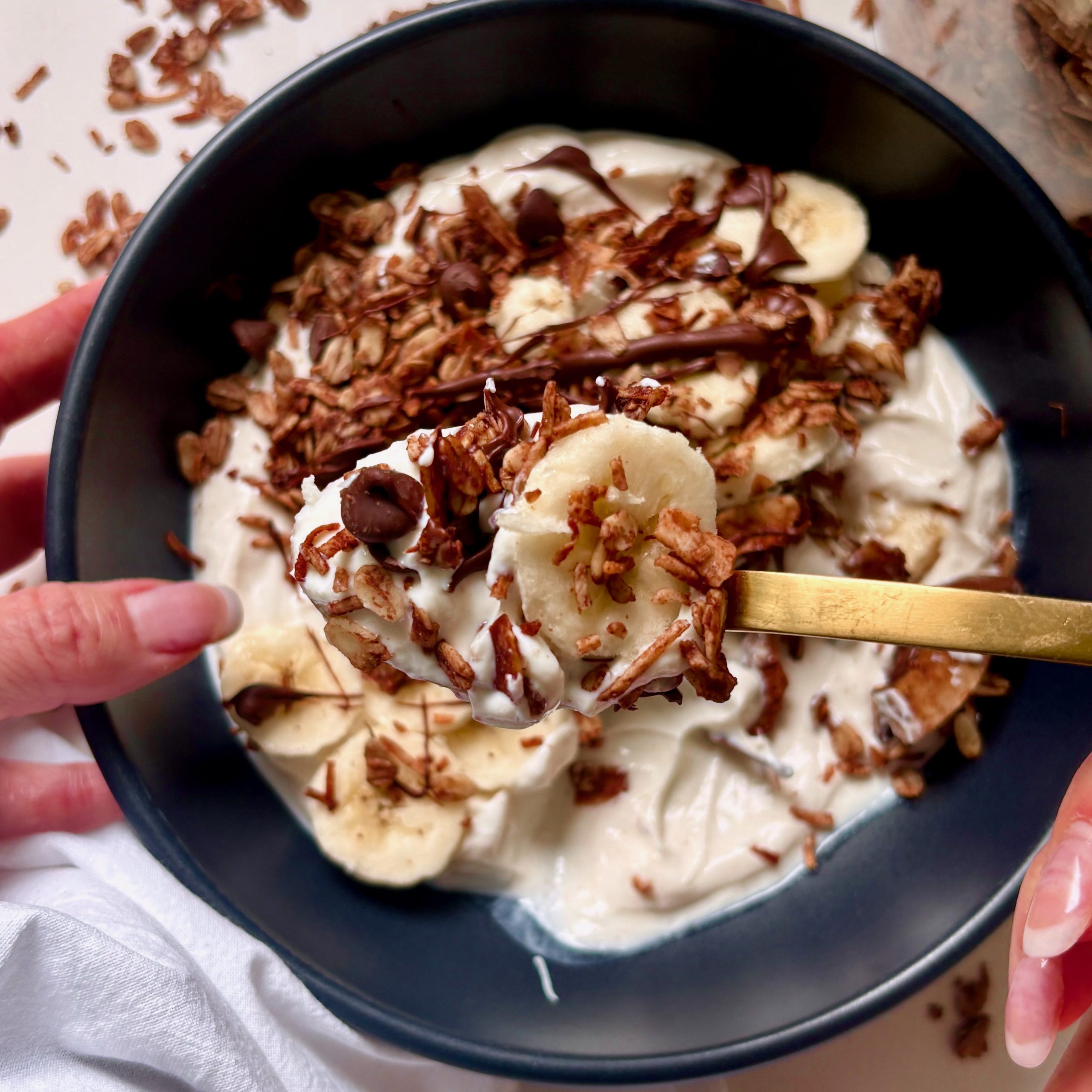 Dark Chocolate Granola on a spoon with banana