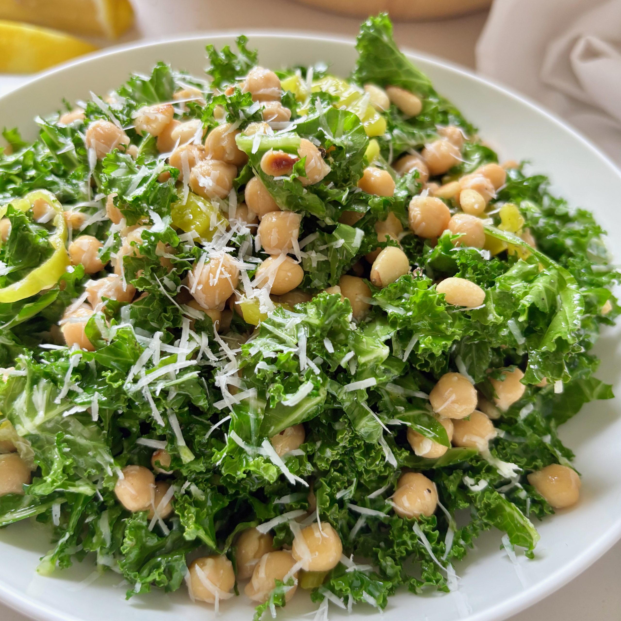 Close-up of kale salad with chickpeas, pepperoncini, and lemon parmesan dressing