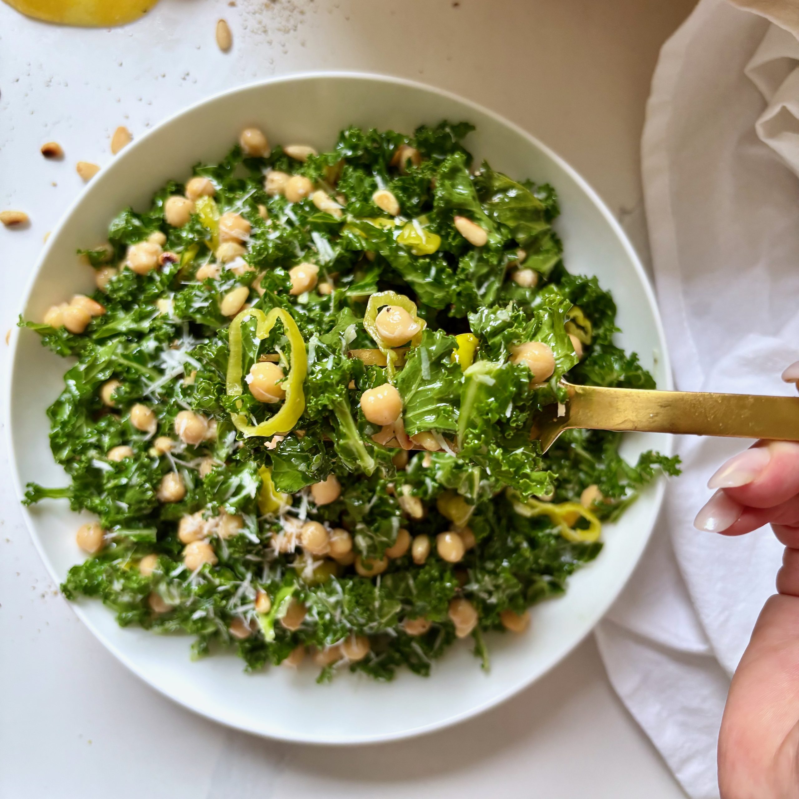Forkful of kale and chickpea salad with peppers and cheese