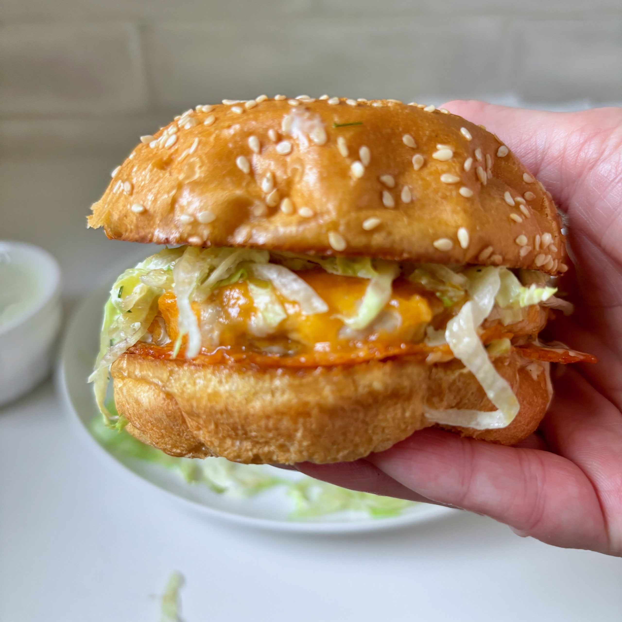 Juicy turkey burger with melty cheddar and pickley sauce on a brioche bun