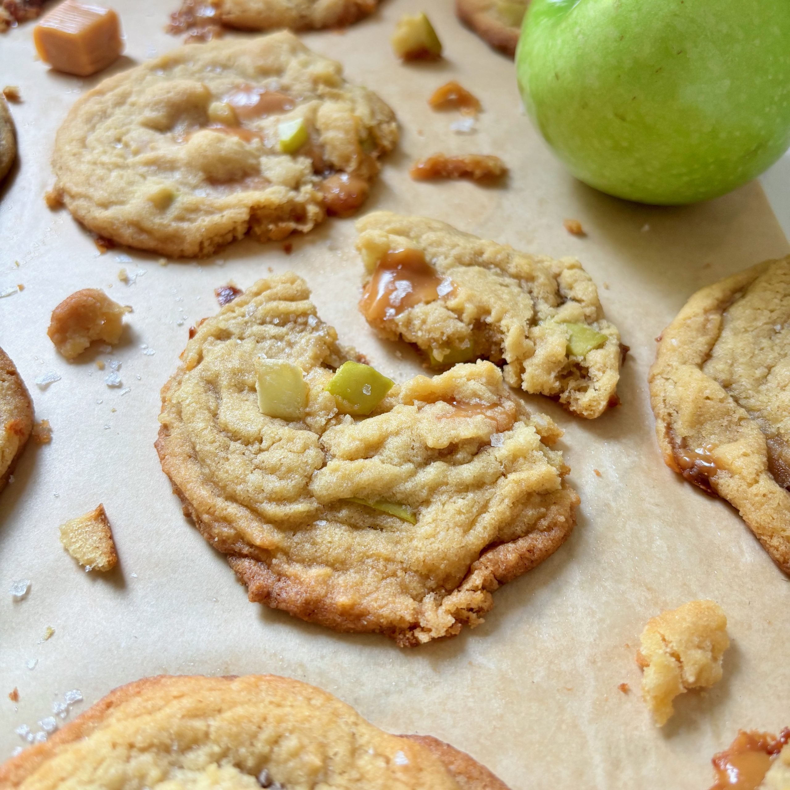 Close-up of caramel apple cookies showing gooey melted caramel and apple pieces