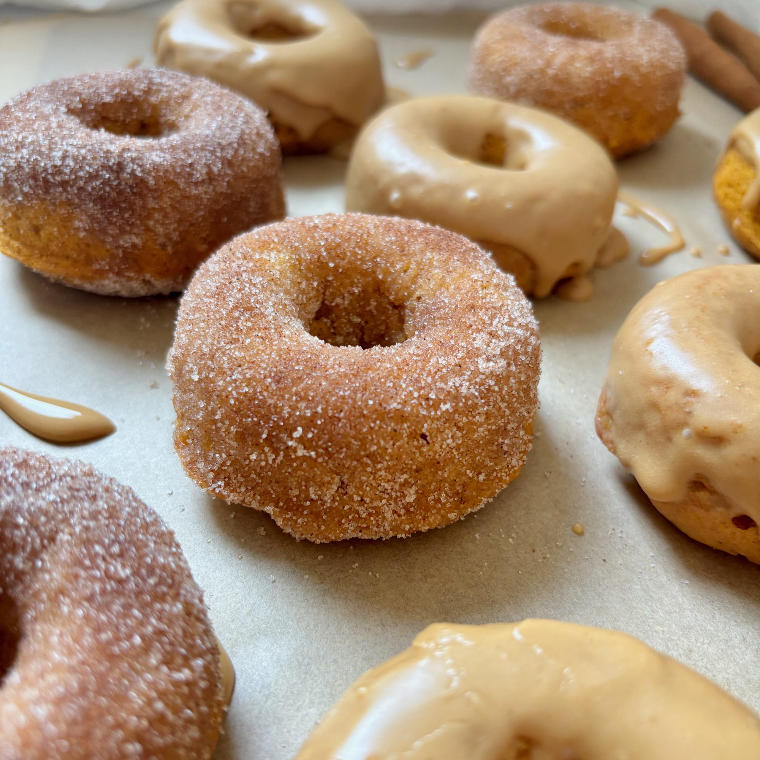 Close-up of glazed baked pumpkin spice latte donuts with espresso cinnamon sugar coating