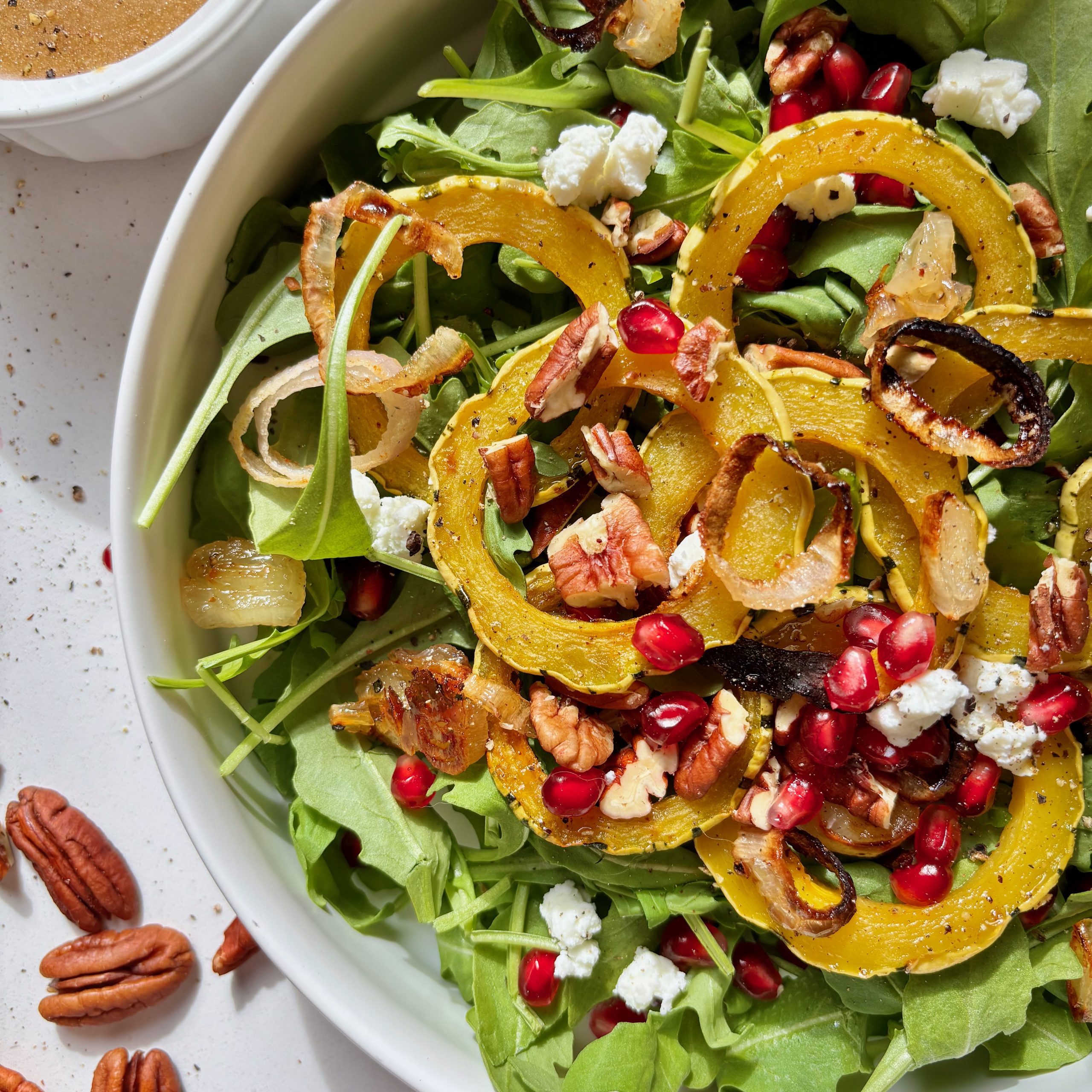 Close-up of maple brown butter dressing over roasted squash salad.