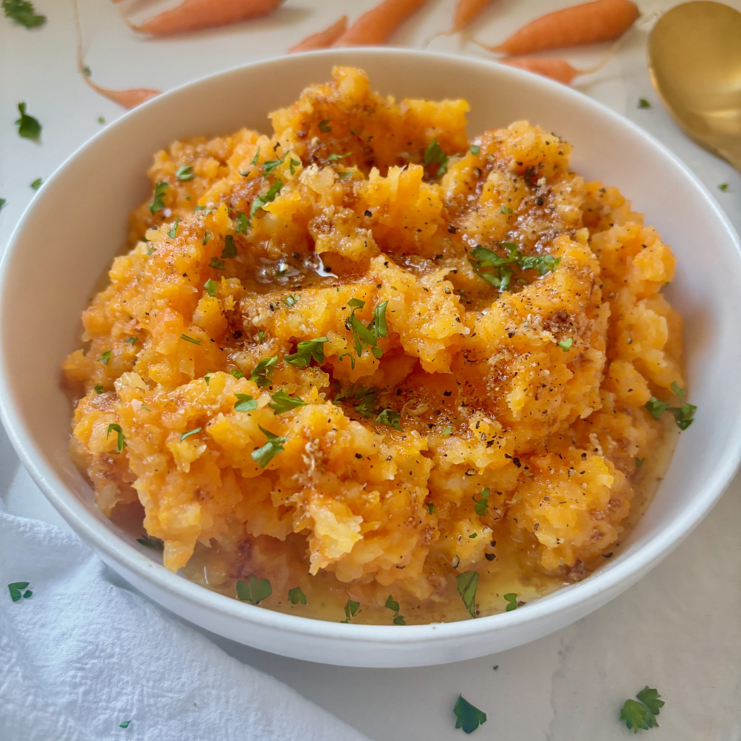 Mashed fall vegetables topped with brown butter and parsley.