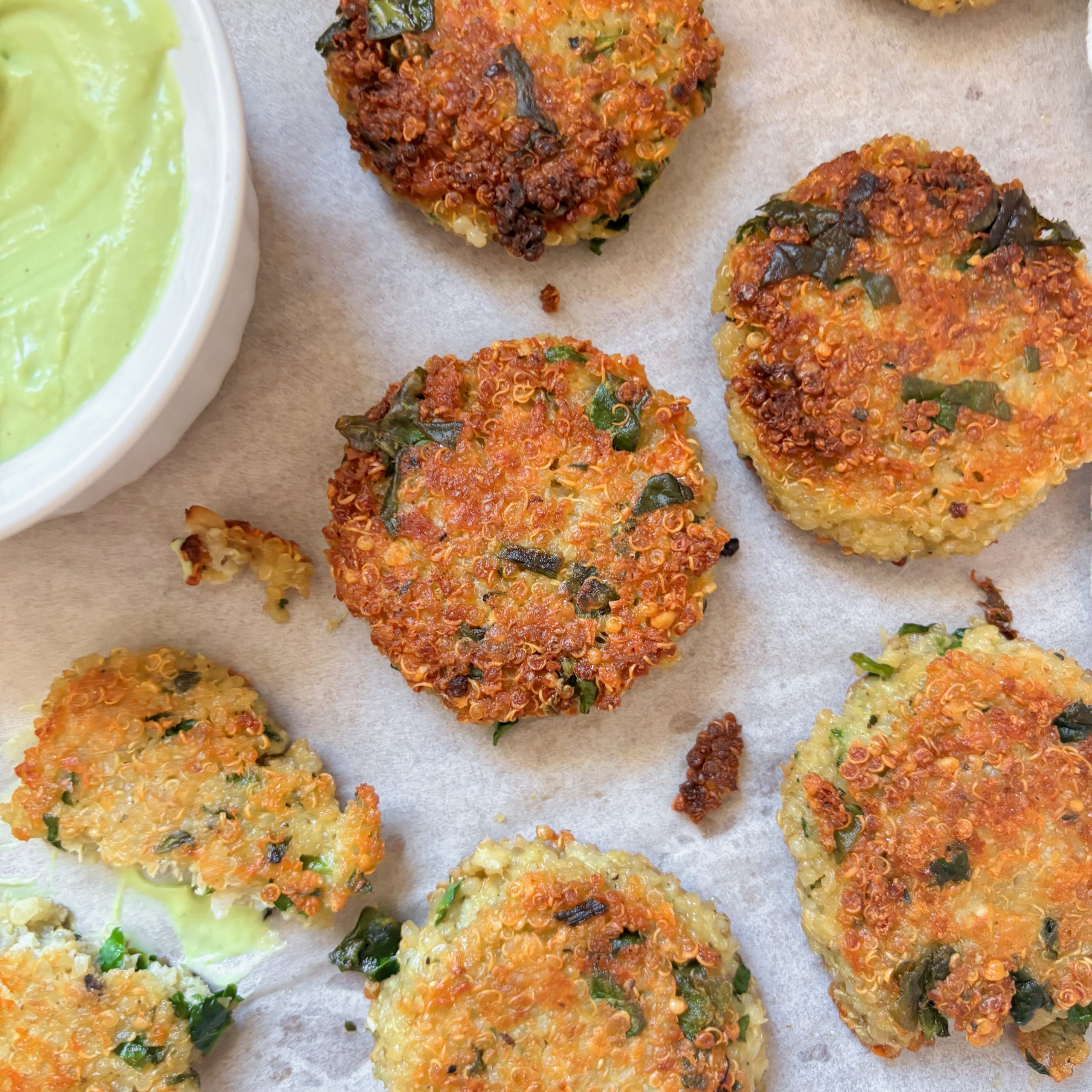 Cheesy spinach quinoa bites served with avocado feta sauce