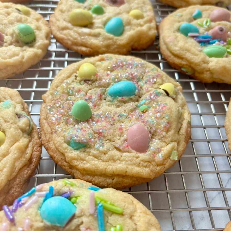 Close-up of mini egg cookies with melted chocolate and crunchy candy shells