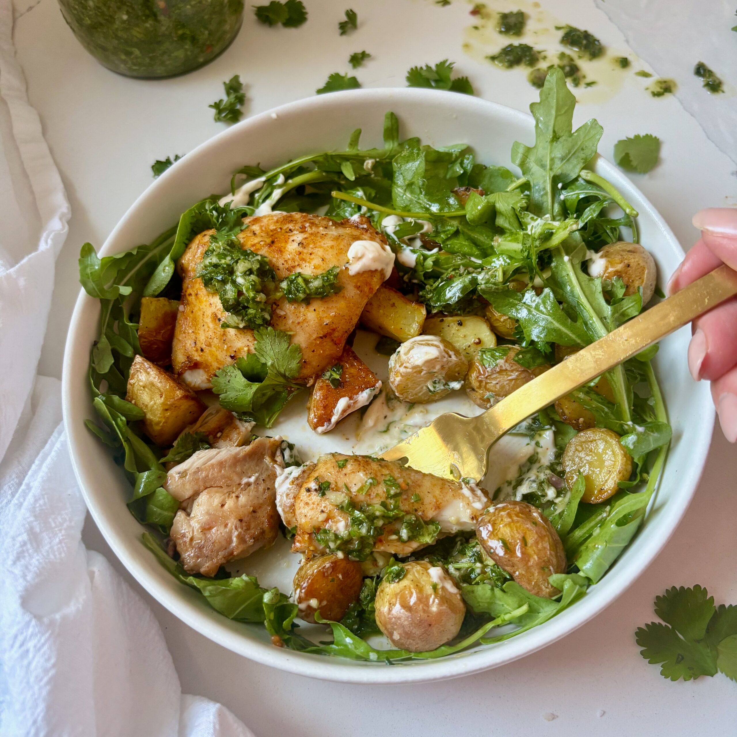 Overhead view Sheet Pan Chimichurri Chicken and Potatoes with sauce