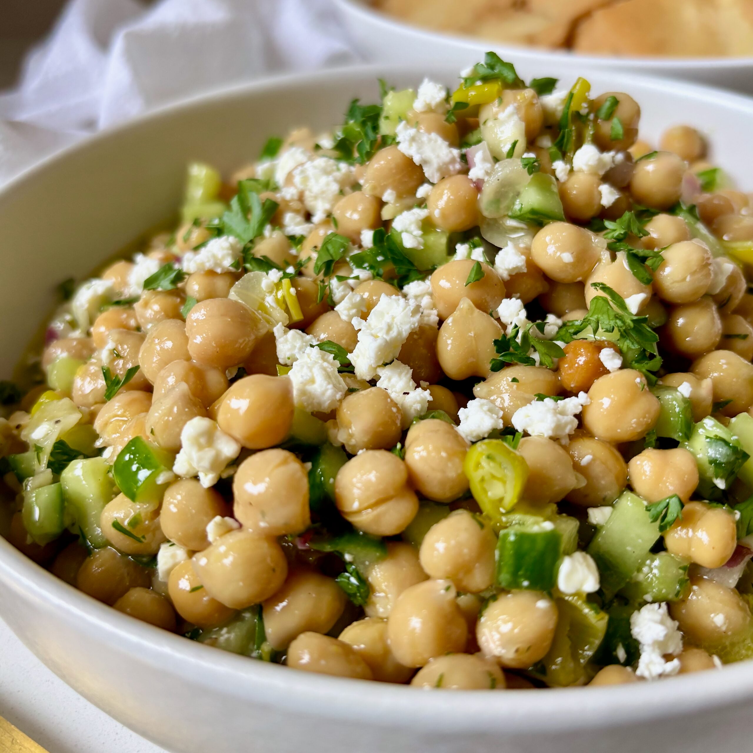 Bowl of Lemon and feta marinated chickpeas with honey dill dressing