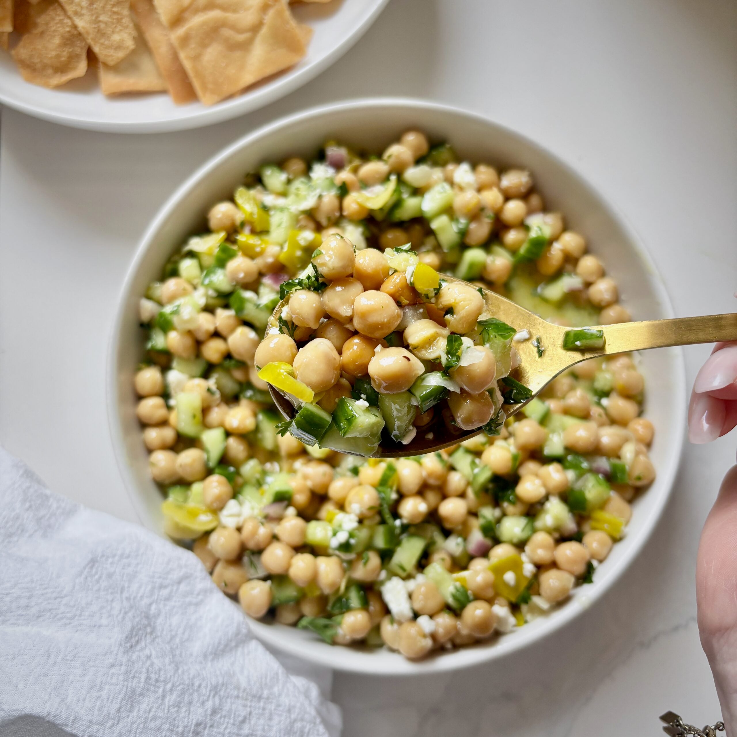 Spoonful of lemon and feta marinated chickpea salad