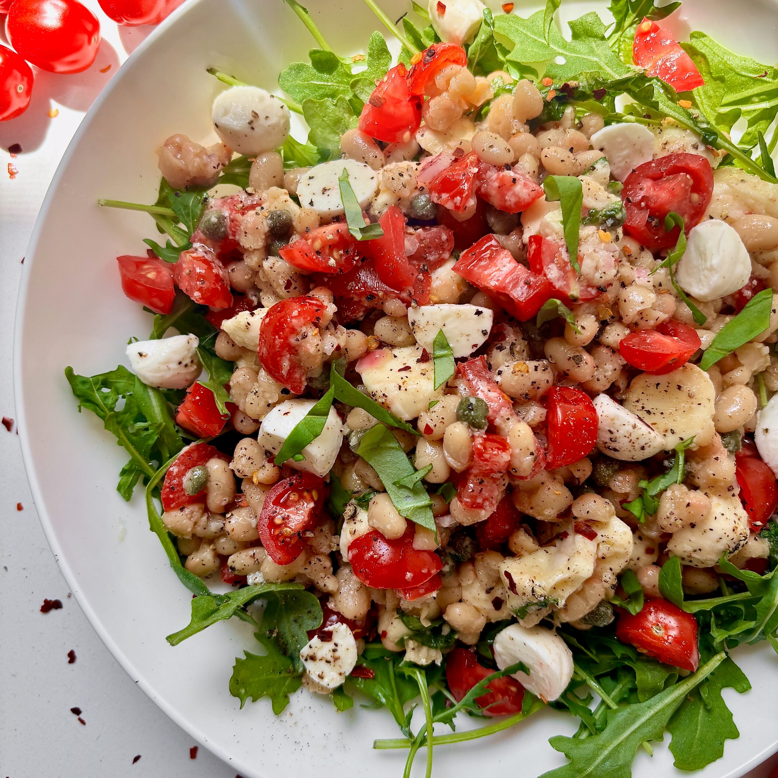 White balsamic parmesan vinaigrette on marinated white bean tomato salad.