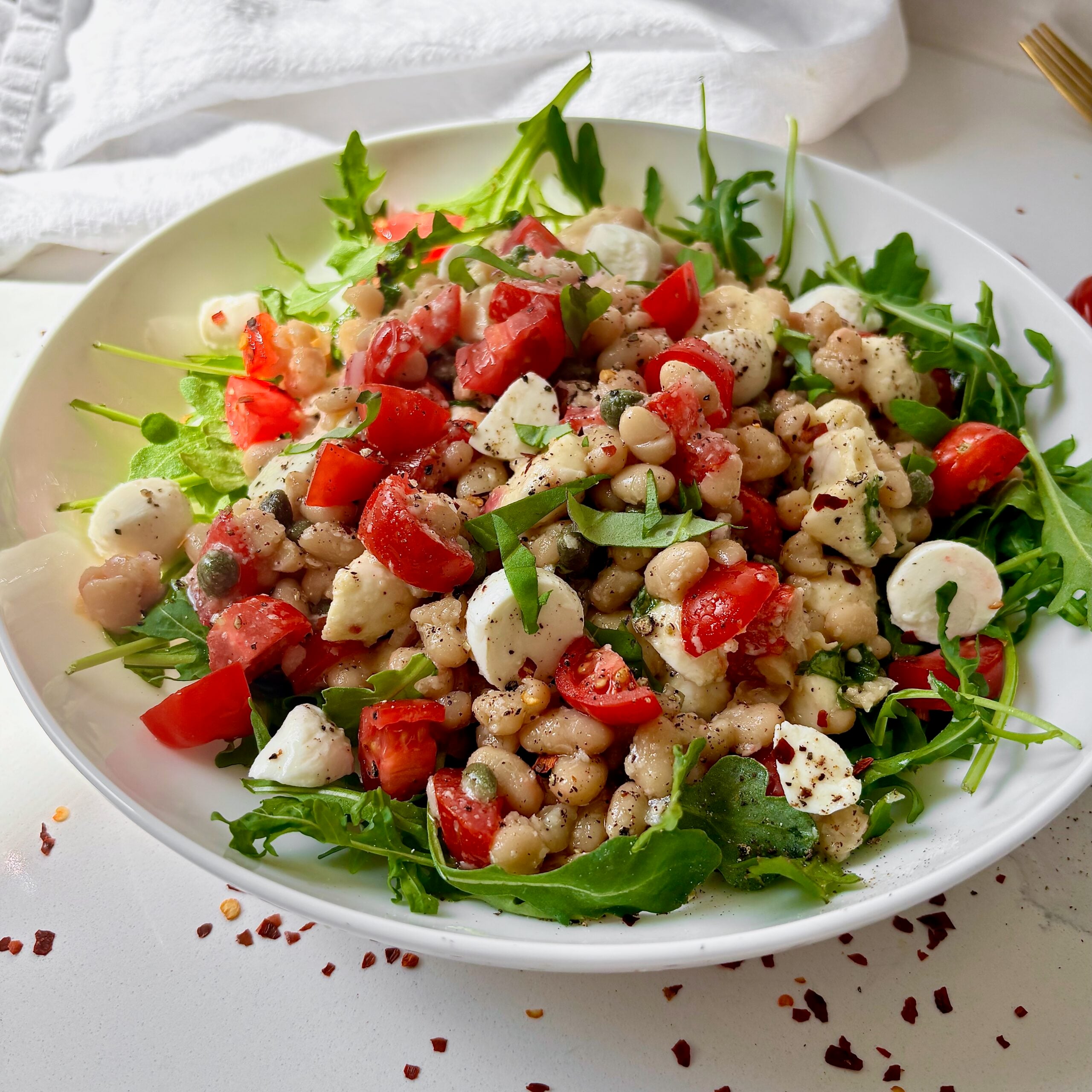 White bean salad with tomatoes, basil, capers, and bocconcini.
