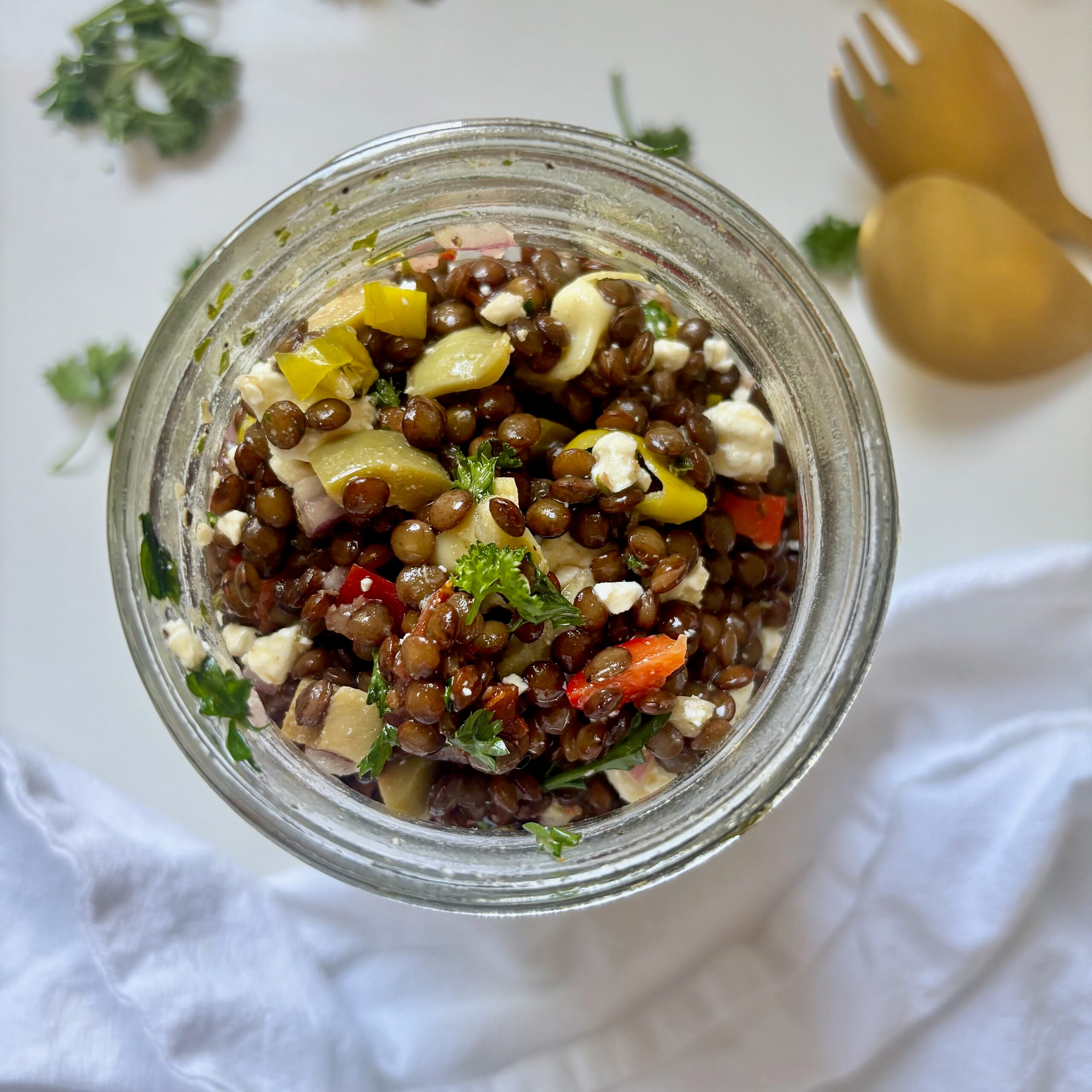 Top view of mediterranean marinated lentil salad in a jar