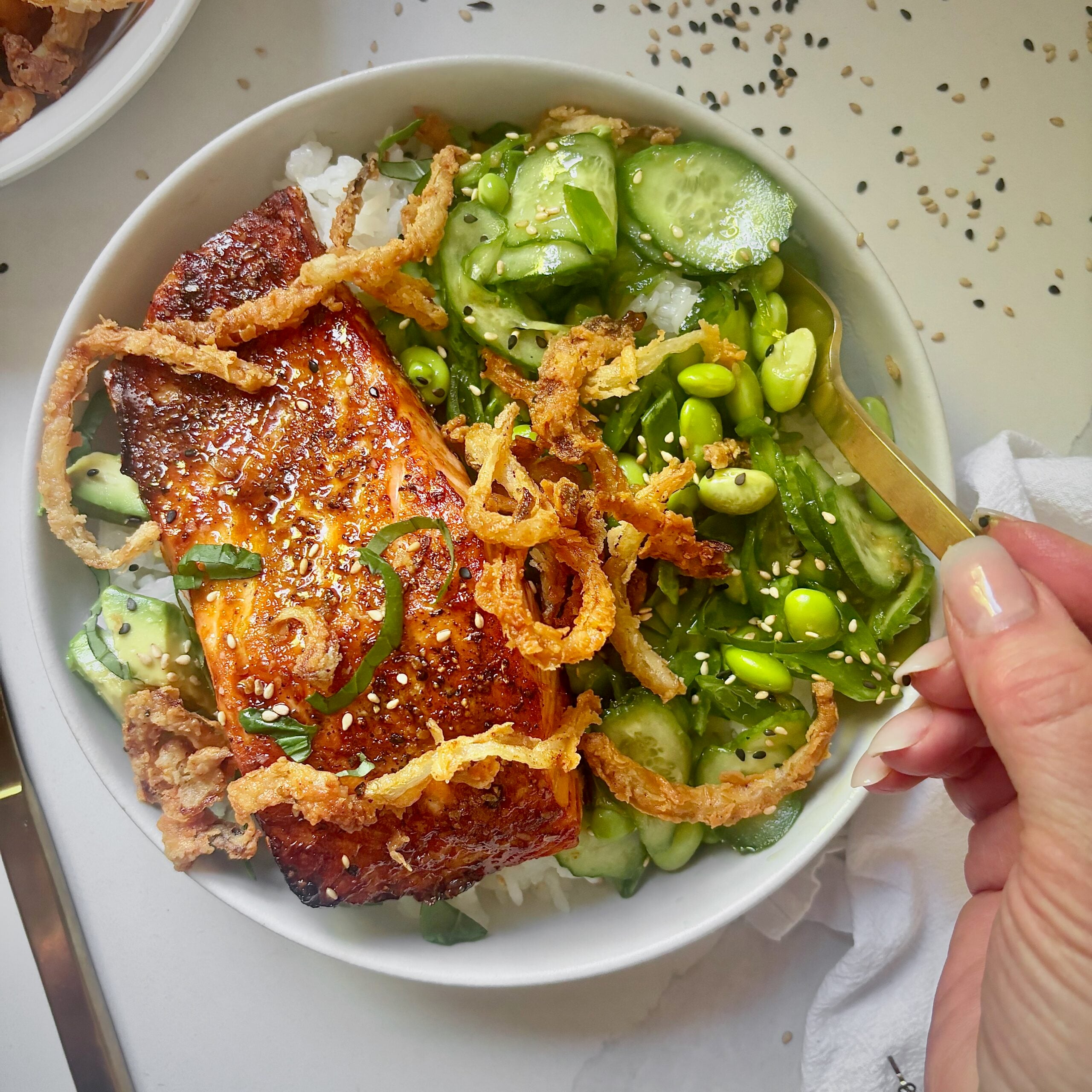 Crunchy Salmon Rice Bowls with avocado, crispy onions, sesame seeds, and soy ginger vegetables.