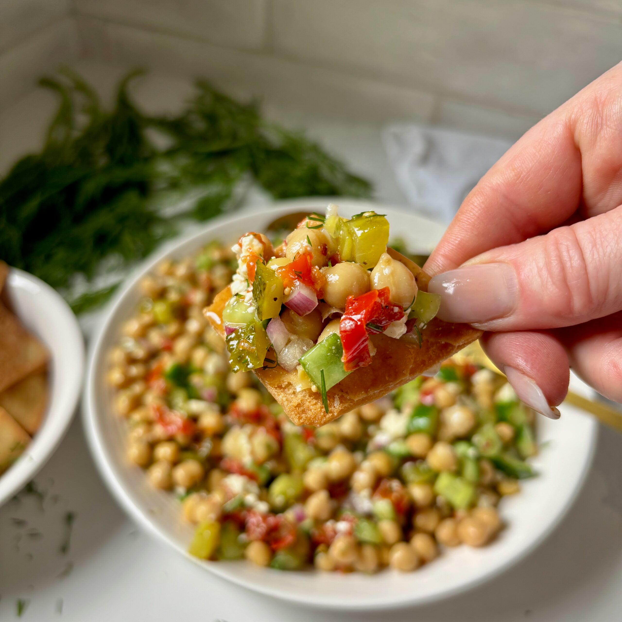 High-protein marinated chickpea salad served with pita chips.