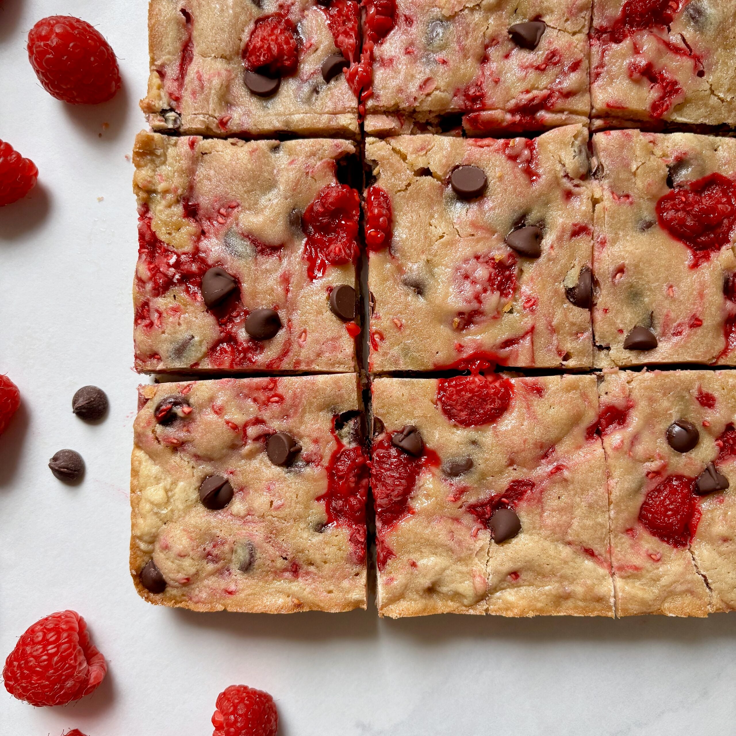Buttery blondies with dark chocolate chips and raspberries.