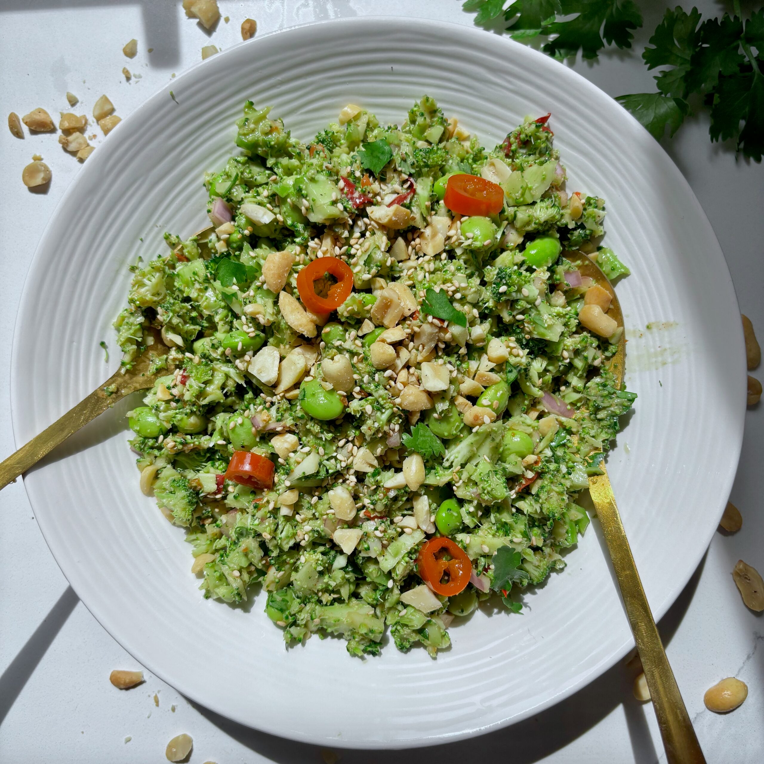 Overhead view of Super Chop Broccoli Salad with sesame seeds and fresh herbs.