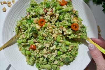 Super Chop Broccoli Salad with edamame and miso ginger dressing served in a white bowl.