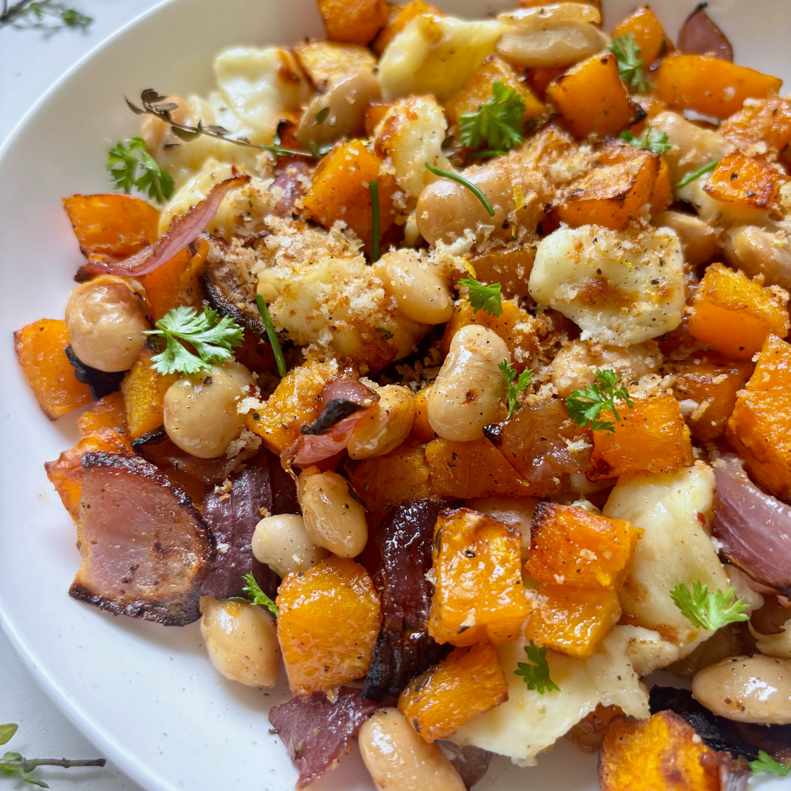 Close-up of roasted butternut squash and halloumi drizzled with white balsamic hot honey