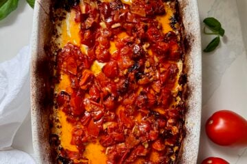 Slow-roasted Calabrian chile tomatoes cooked until jammy and glossy in a baking dish.