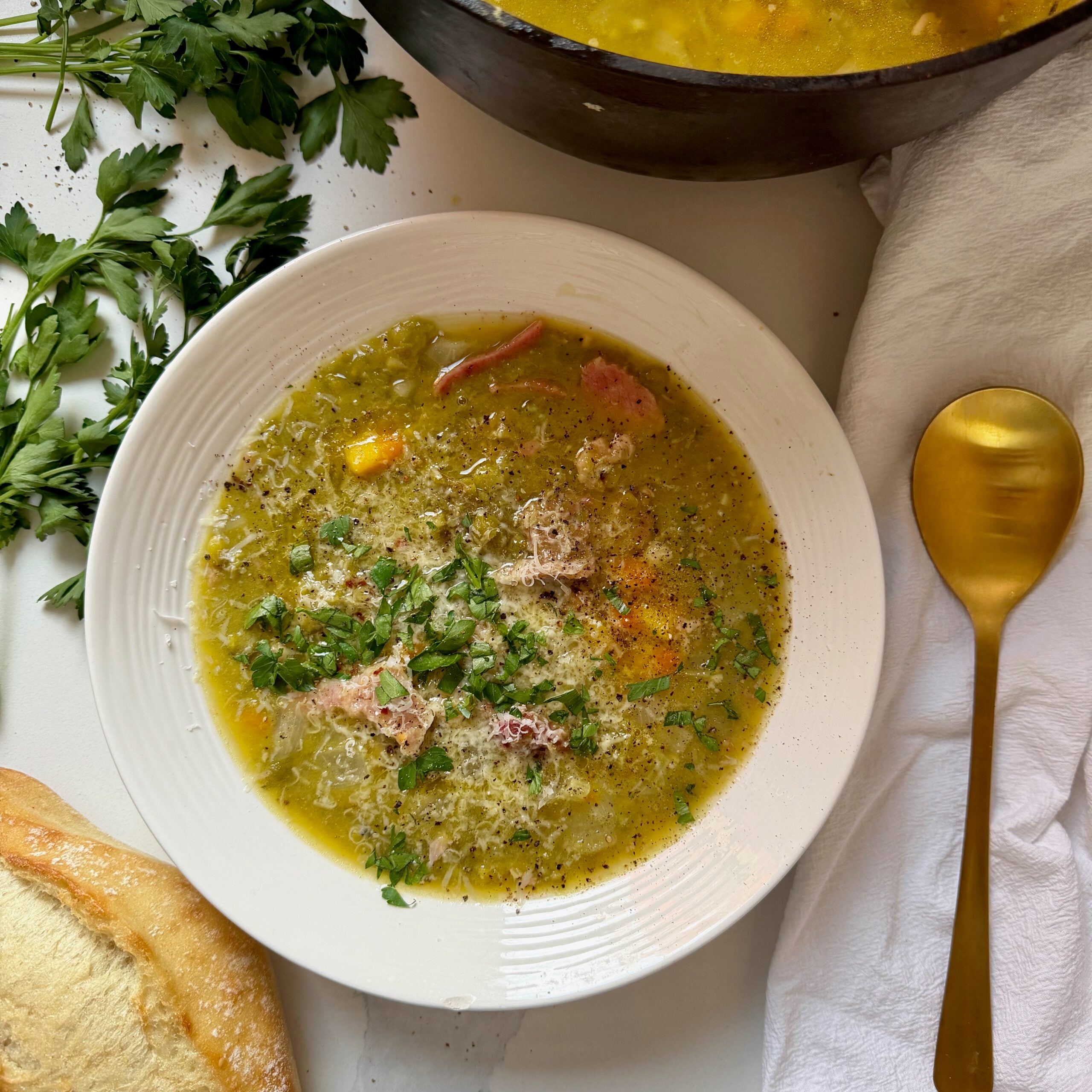 Old-fashioned split pea and ham soup topped with melted garlic butter and fresh parsley.