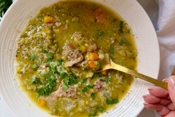 Homemade split pea and ham soup topped with chili garlic butter, grated Parmesan and fresh parsley
