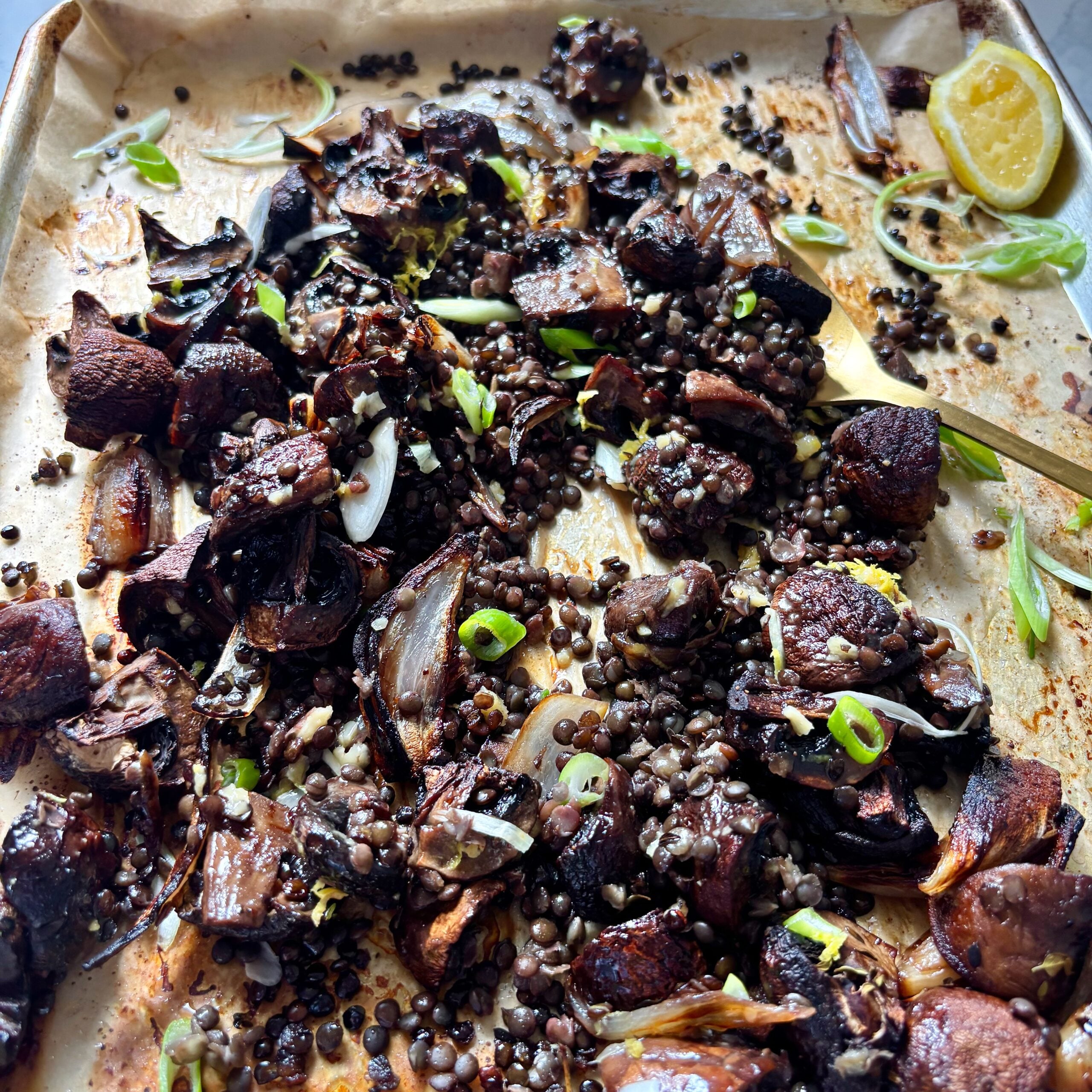 Miso butter mushrooms with roasted shallots, black lentils and lemon.