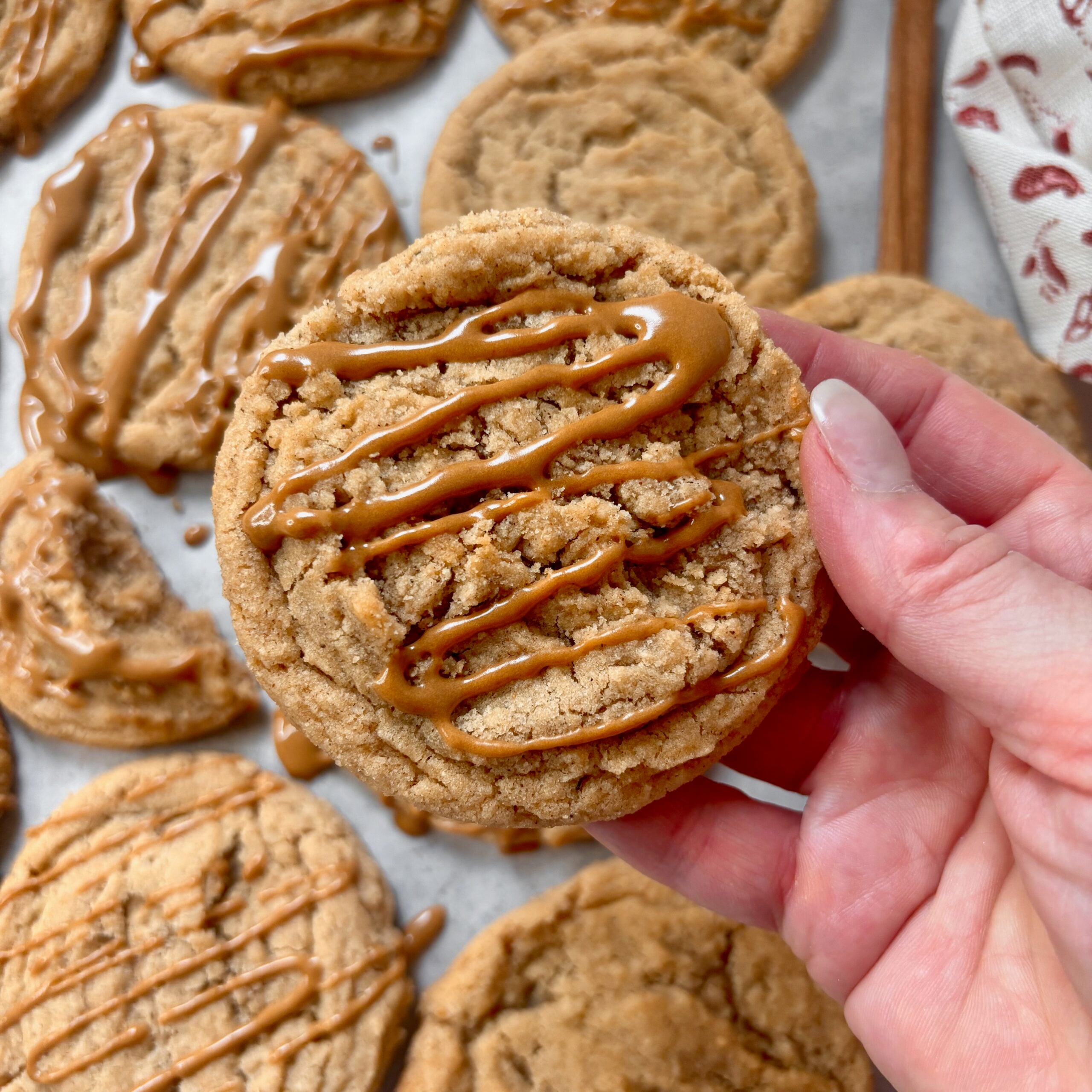 Hand holding Chewy dirty chai cookies with espresso glaze